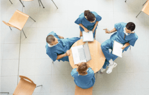 doctors and healthcare professionals sitting around a table. Document solutions image