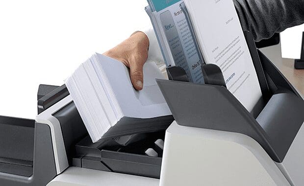 Quadient DS-35 folder inserter with woman's hand adding envelopes