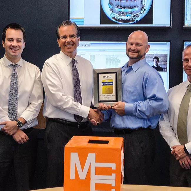 Security Solutions salespeople accepting an award from Chris Throckmorton of exacvision