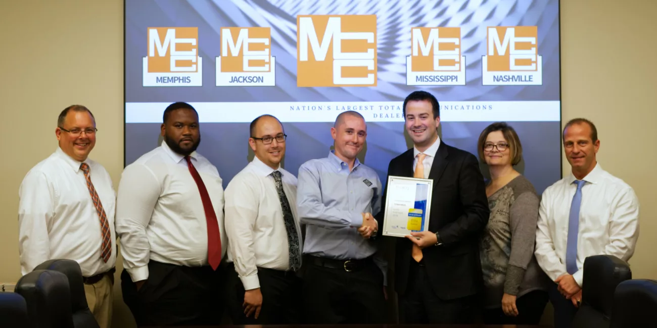 MCC Security Solutions staff gather to accept an award from Exacqvision.
