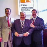 Scot Berry (left) and Shane Berry (right) present Dean Berry (middle) with the first check for the purchase of Memphis Communications Corporation (MCC).