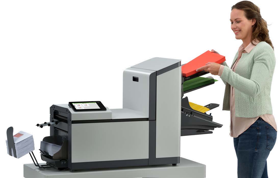 Woman using a Quadient DS-70 folder inserter for faster mail assembly