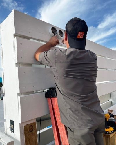 Security technician installing security cameras