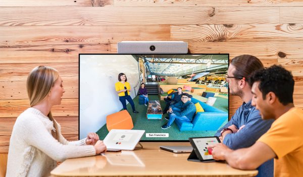 Cisco huddle space with three people sitting around watching a Webex meeting. MCC Office Technology Solutions