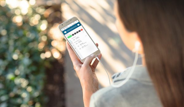 Woman holding a cellphone showing Webex Calling