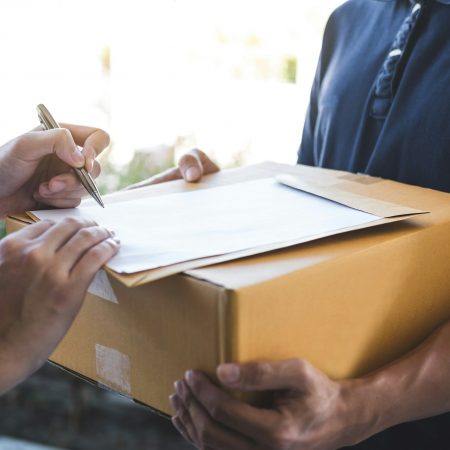 Delivery mail man giving parcel box to recipient