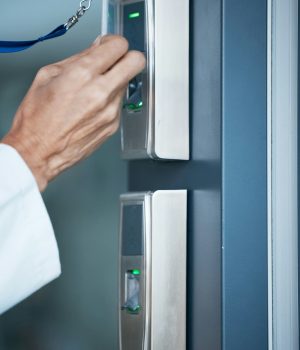 Hand, key card and scan on security door for entrance, access control and safety in business, prope