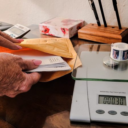 Mailing letters with proper postage due using package scale in workspace.