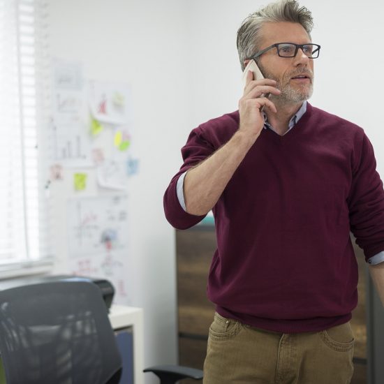 man in an office on the phone