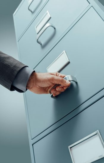 Office clerk searching files in the filing cabinet