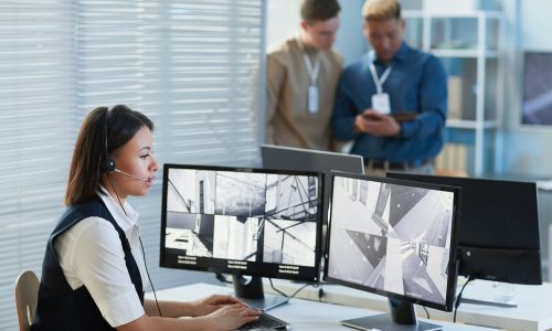 Female security guard watching CCTV security cameras