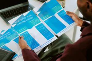young-adult-black-man-reading-real-estate-brochure