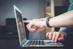 Person using laptop for document automation to boost productivity