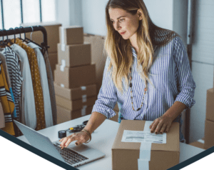 Woman comparing shipping label on package to computer